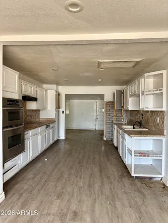 a large kitchen with a stove top oven