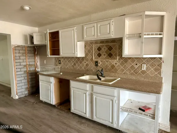 a kitchen with stainless steel appliances granite countertop a sink and cabinets