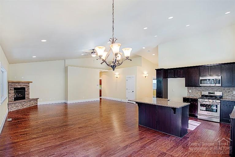 19097 Baker Road Bend, OR 97702 - Photo 5 of 16 a kitchen with stainless steel appliances granite countertop wooden floors and granite counter tops