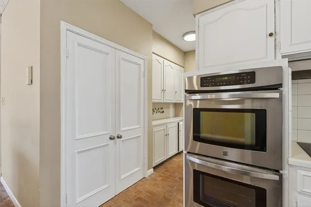 a kitchen with cabinets and steel stainless steel appliances
