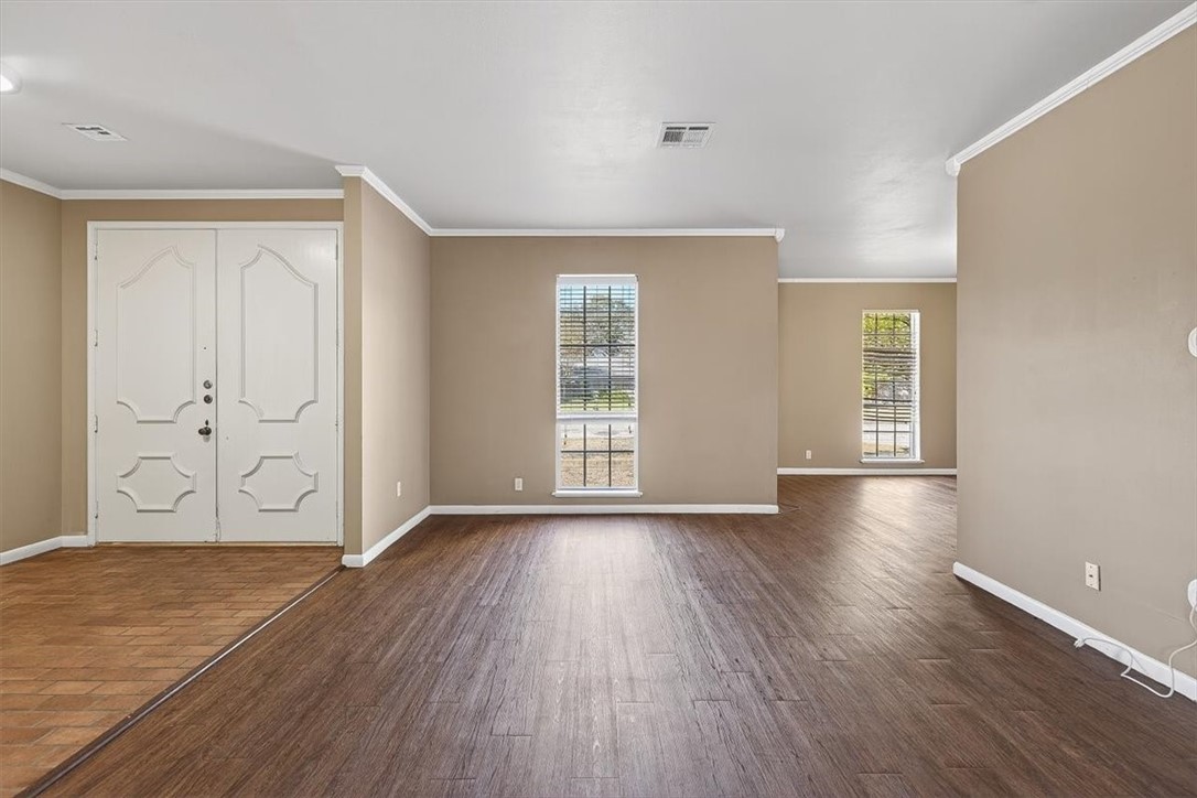 6418 Long Circle Corpus Christi, TX 78413 - Photo 4 of 40 an empty room with wooden floor and windows
