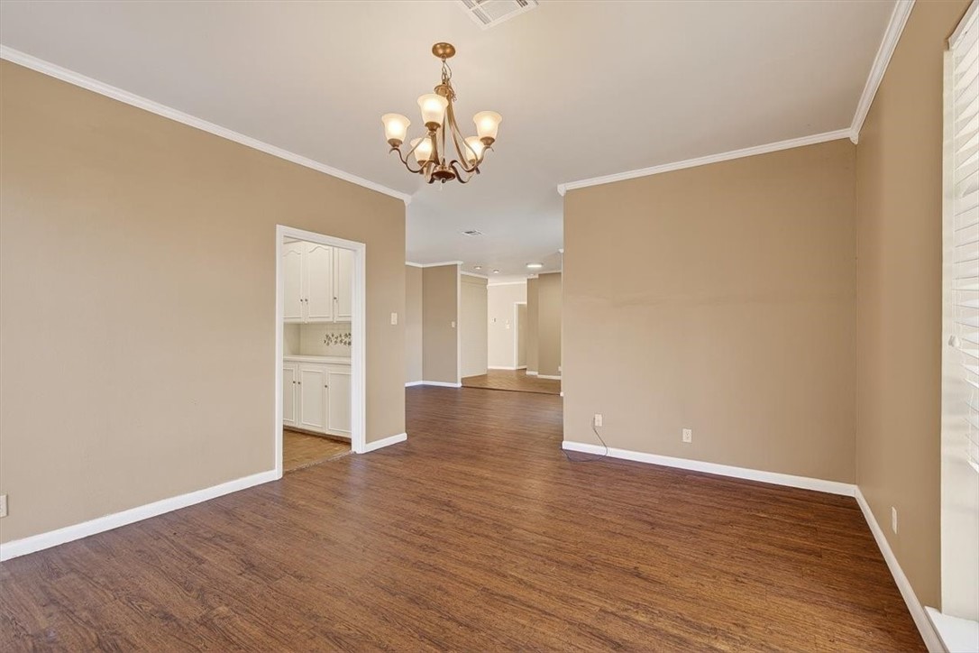 6418 Long Circle Corpus Christi, TX 78413 - Photo 8 of 40 a view of an empty room with wooden floor and a window