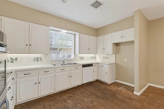 a kitchen with sink and cabinets