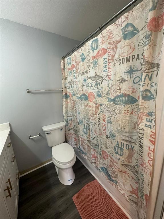 1023 South Hiawassee Road, Unit 4022 Orlando, FL 32835 - Photo 11 of 24 a white toilet sitting next to a shower curtain