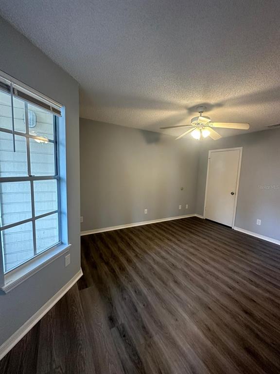 1023 South Hiawassee Road, Unit 4022 Orlando, FL 32835 - Photo 12 of 24 an empty room with wooden floor and windows