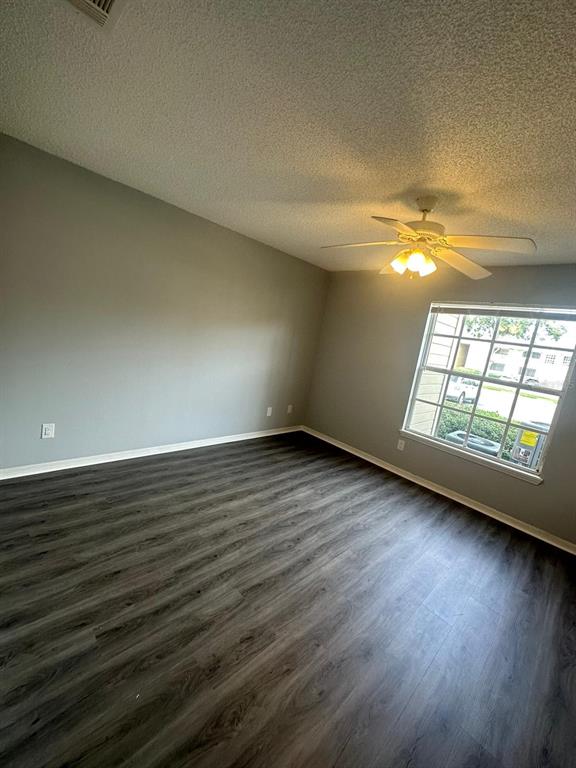1023 South Hiawassee Road, Unit 4022 Orlando, FL 32835 - Photo 13 of 24 an empty room with wooden floor and windows