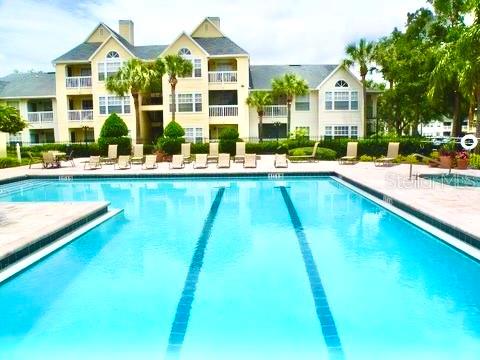 1023 South Hiawassee Road, Unit 4022 Orlando, FL 32835 - Photo 2 of 24 a view of swimming pool with outdoor seating