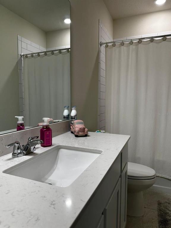 1023 South Hiawassee Road, Unit 4022 Orlando, FL 32835 - Photo 7 of 24 a bathroom with a sink vanity mirror and toilet
