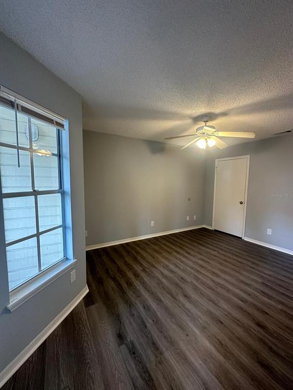 1023 South Hiawassee Road, Unit 4022 Orlando, FL 32835 - Photo 10 of 24 an empty room with wooden floor and windows