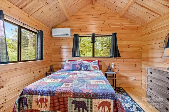 a bed sitting in a bedroom next to a window
