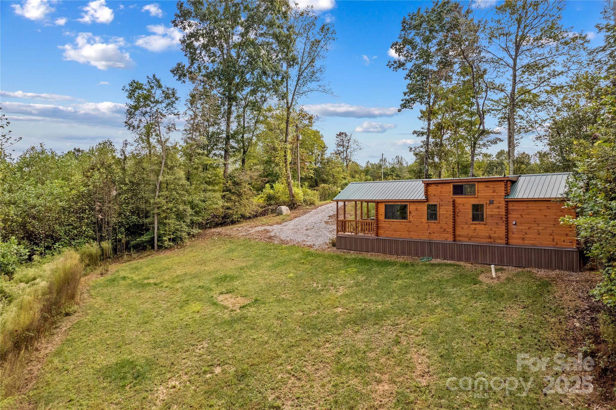 1136 Bauguess Mill Road Traphill, NC 28685 - Photo 29 of 37 a view of a big yard with plants and large trees