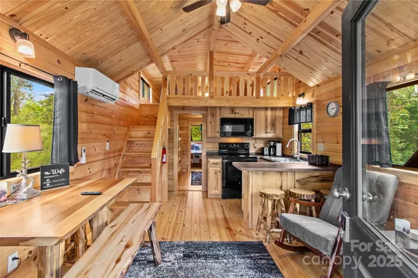 a view of a kitchen with kitchen island granite countertop a sink and counter top space