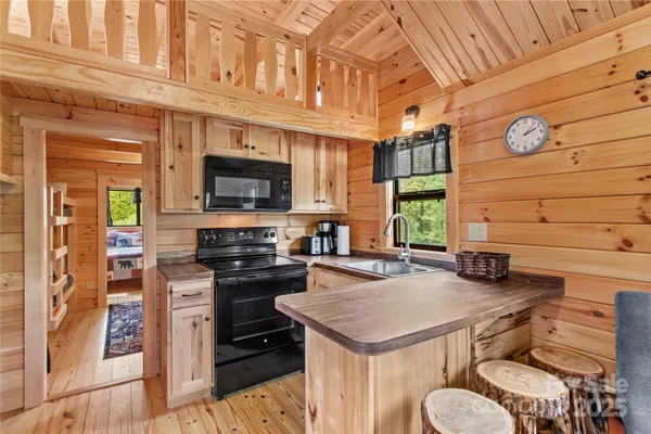a kitchen with granite countertop a stove and a microwave