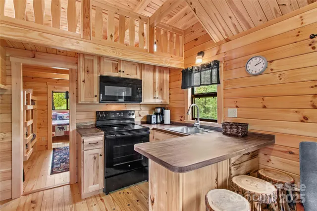 a kitchen with granite countertop a stove and a microwave