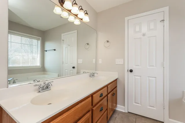 a bathroom with a sink a mirror and a shower