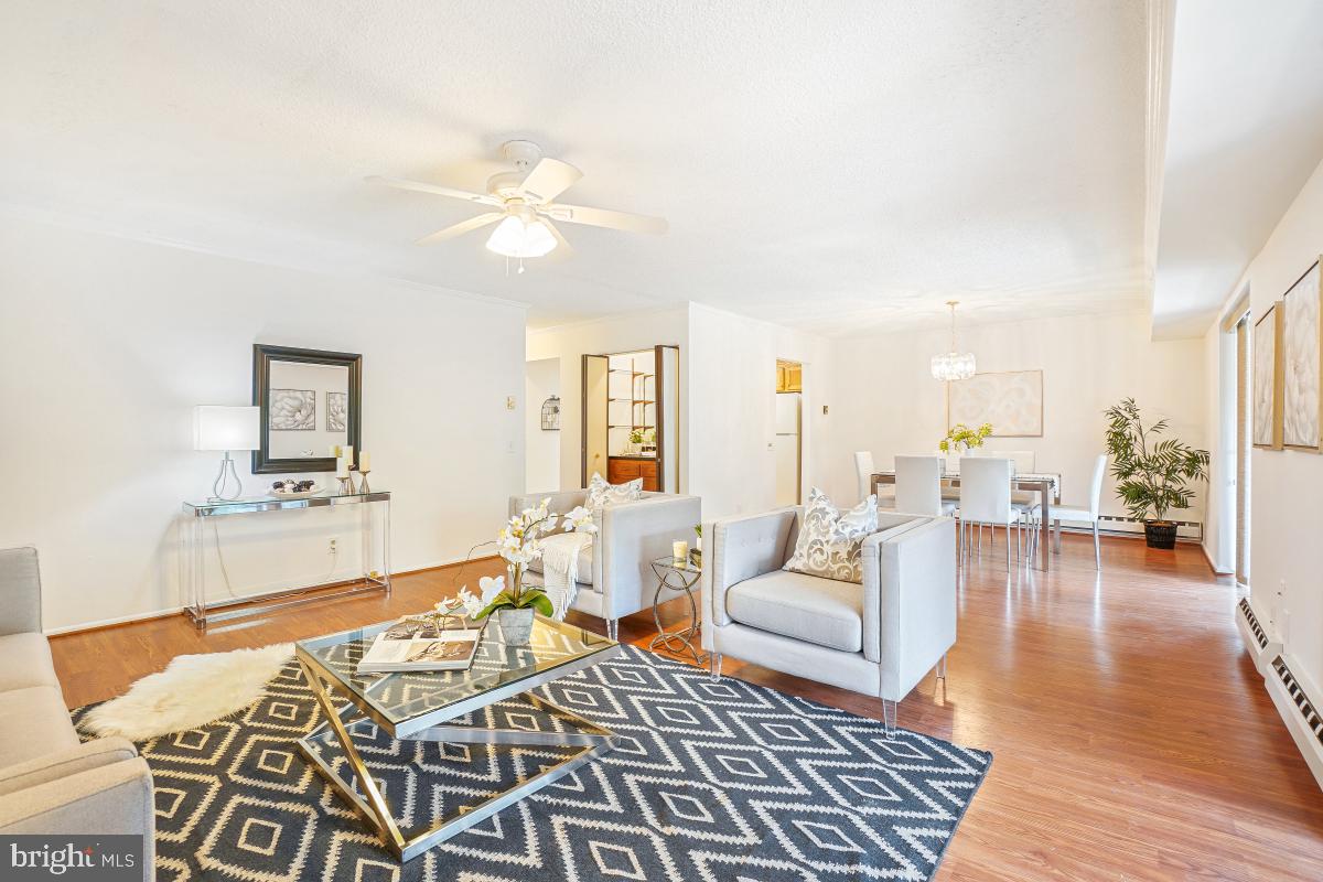 3511 Forest Edge Drive, Unit 173C Silver Spring, MD 20906 - Photo 1 of 52 a living room with furniture and wooden floor