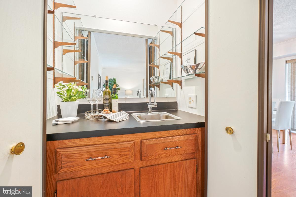 3511 Forest Edge Drive, Unit 173C Silver Spring, MD 20906 - Photo 9 of 52 a bathroom with a granite countertop sink and a mirror