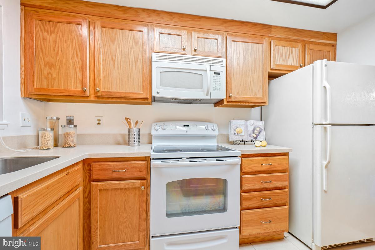 3511 Forest Edge Drive, Unit 173C Silver Spring, MD 20906 - Photo 10 of 52 a kitchen with stainless steel appliances granite countertop a refrigerator sink and cabinets