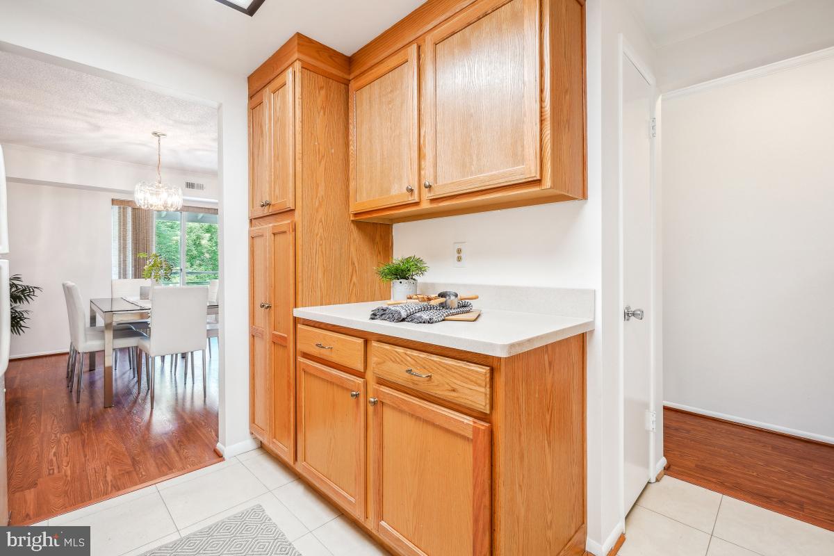 3511 Forest Edge Drive, Unit 173C Silver Spring, MD 20906 - Photo 11 of 52 a kitchen with stainless steel appliances granite countertop a stove a sink and a refrigerator with wooden floor