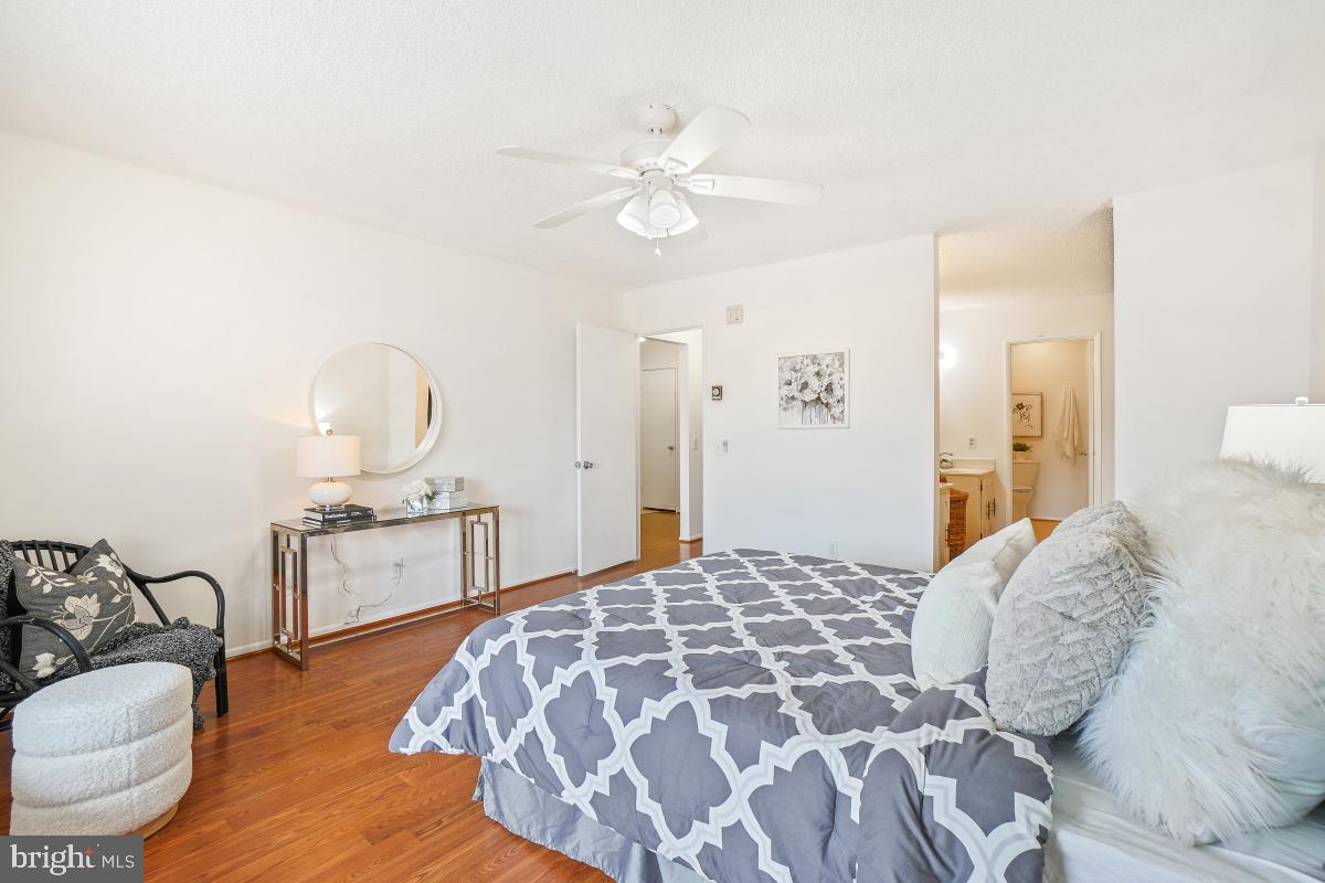 3511 Forest Edge Drive, Unit 173C Silver Spring, MD 20906 - Photo 15 of 52 a bedroom with a bed and a chandelier
