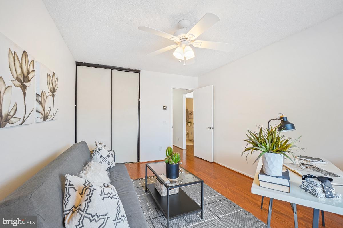 3511 Forest Edge Drive, Unit 173C Silver Spring, MD 20906 - Photo 19 of 52 a living room with furniture and wooden floor