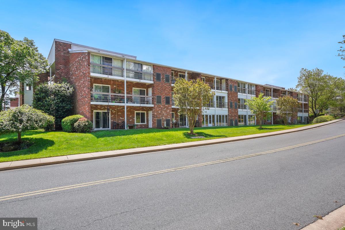 3511 Forest Edge Drive, Unit 173C Silver Spring, MD 20906 - Photo 25 of 52 a view of a building with a yard