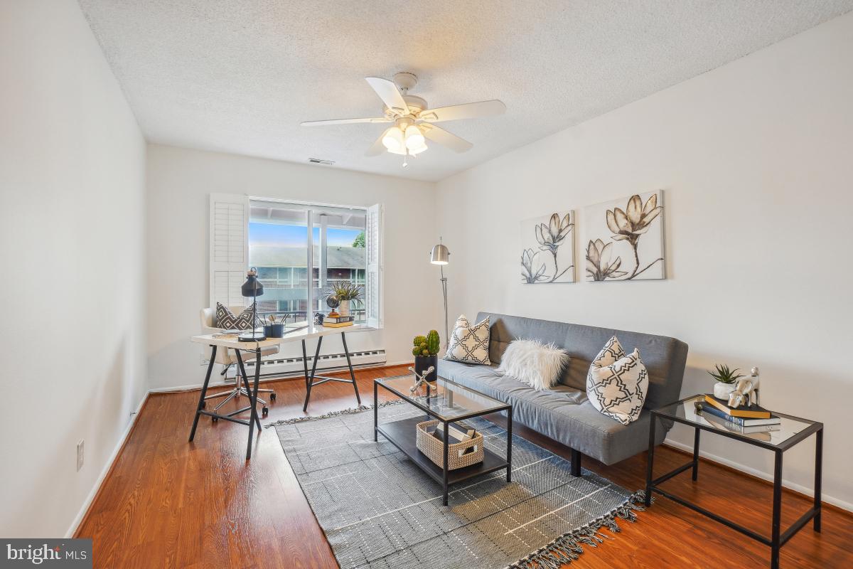 3511 Forest Edge Drive, Unit 173C Silver Spring, MD 20906 - Photo 4 of 52 a living room with furniture and a wooden floor