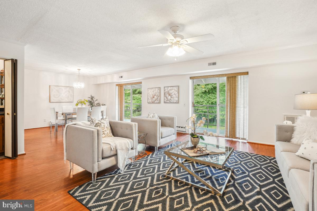 3511 Forest Edge Drive, Unit 173C Silver Spring, MD 20906 - Photo 5 of 52 a living room with furniture and wooden floor