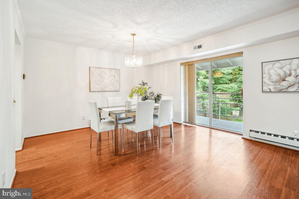 3511 Forest Edge Drive, Unit 173C Silver Spring, MD 20906 - Photo 6 of 52 a dining room with furniture window wooden floor