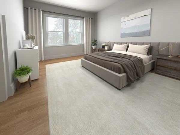 a bedroom with a bed and a large window