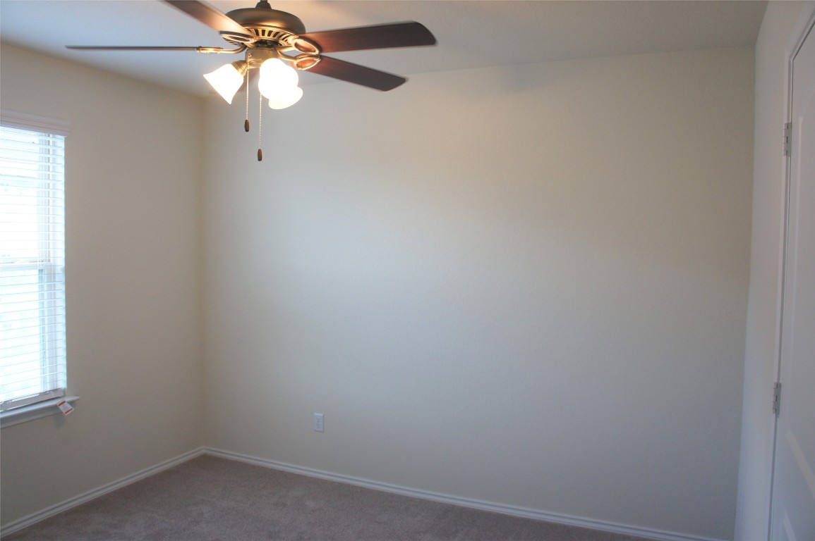 1612 Cliffbrake Way Georgetown, TX 78626 - Photo 11 of 13 an empty room with windows and fan