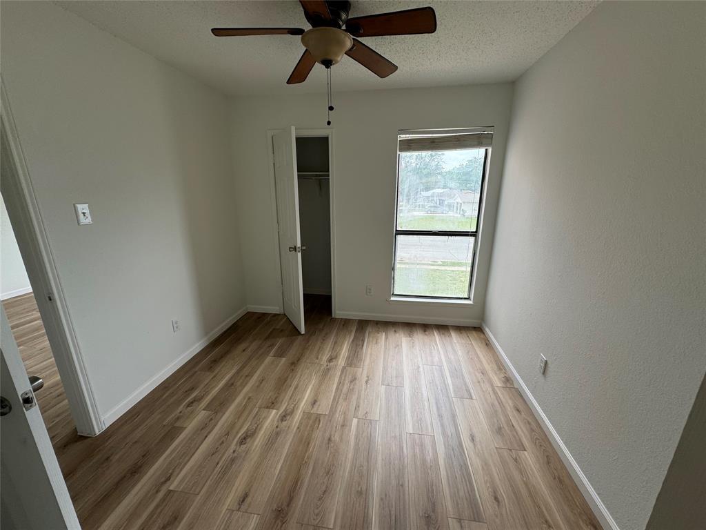 7413 Bogart Drive North Richland Hills, TX 76180 - Photo 3 of 9 a view of an empty room with wooden floor and a window