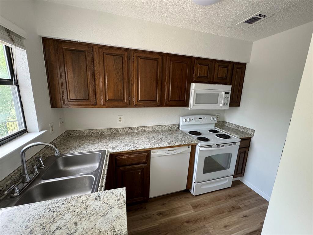7413 Bogart Drive North Richland Hills, TX 76180 - Photo 8 of 9 a kitchen with a sink stove and cabinets