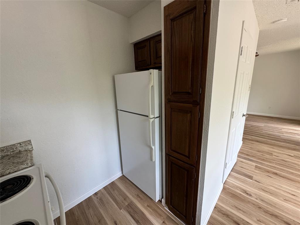 7413 Bogart Drive North Richland Hills, TX 76180 - Photo 9 of 9 a view of a storage and utility room with wooden floor