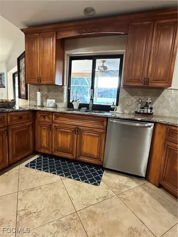 a kitchen with a sink a stove top oven a counter space and cabinets