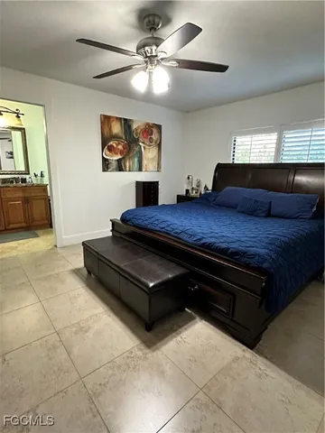 a living room with a bed furniture and a flat screen tv
