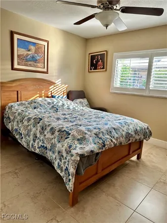 a bedroom with a bed and painting on the wall