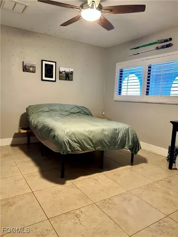 a bed sitting in a bedroom next to a window