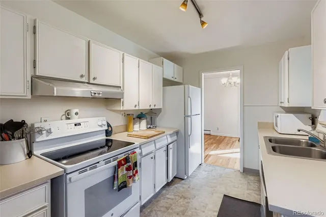 a kitchen with a sink stove and refrigerator