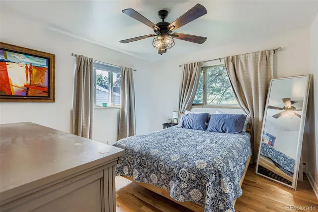 a bedroom with a bed and a table with the outer view