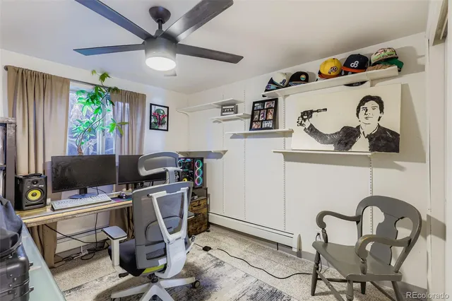 a view of a workspace with furniture and a window