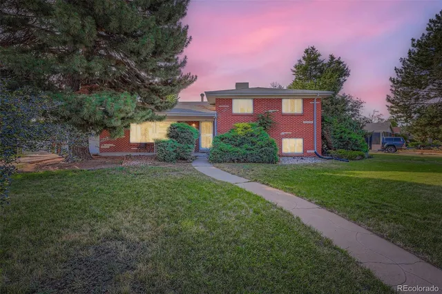 a front view of a house with a yard and outdoor seating