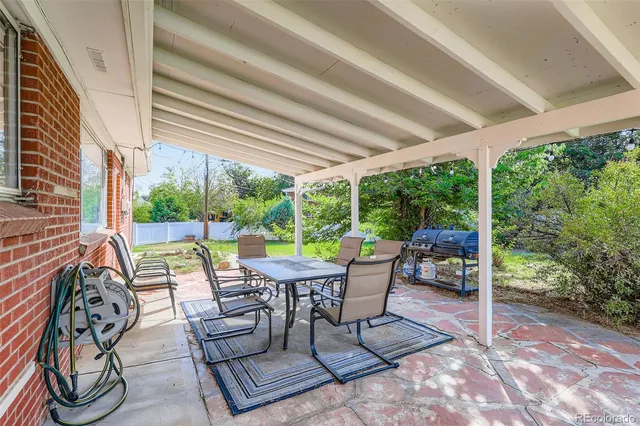 a view of a patio with couple of chairs and a table in a patio