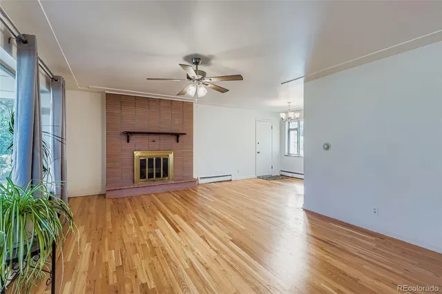 wooden floor in an empty room with a fireplace