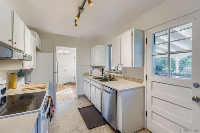 a kitchen with a sink stove and refrigerator