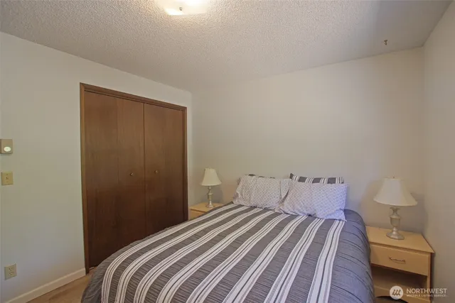 a bedroom with a bed and a night stand