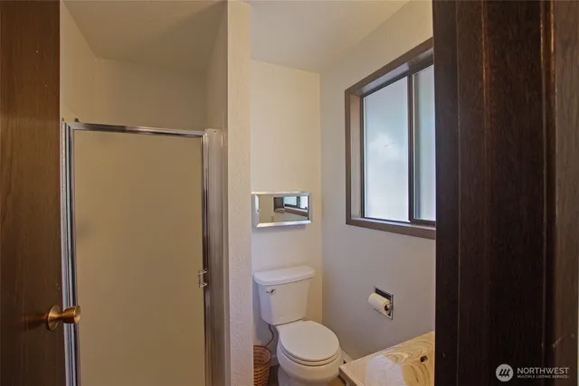 a white toilet sitting next to a bathroom sink