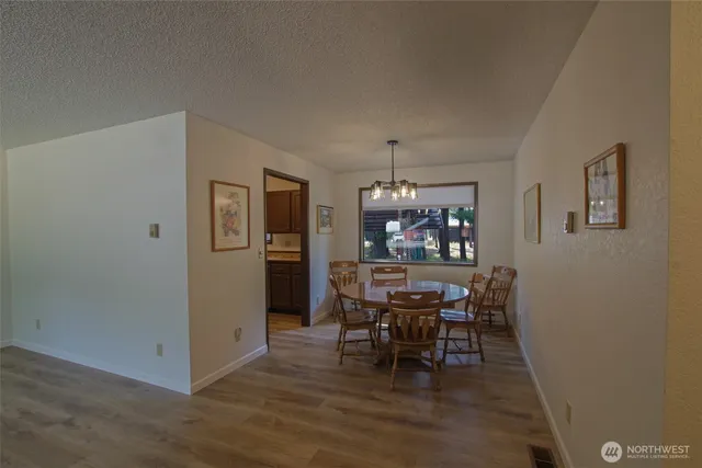a view of a dining room with furniture and chandelier