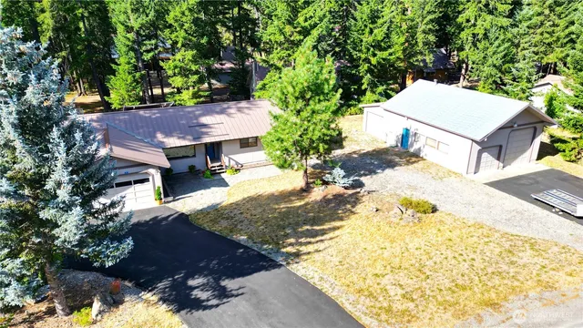 a view of a backyard with a house and large trees