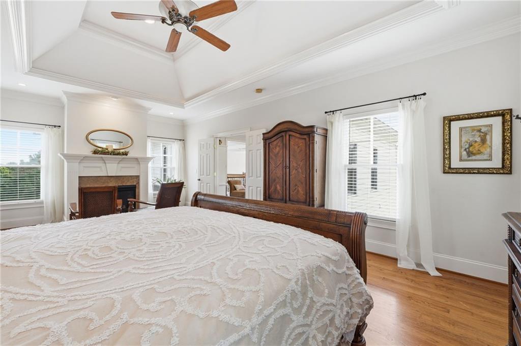 3535 Dr Bramblett Road Cumming, GA 30028 - Photo 31 of 91 a spacious bedroom with a large bed and a fireplace